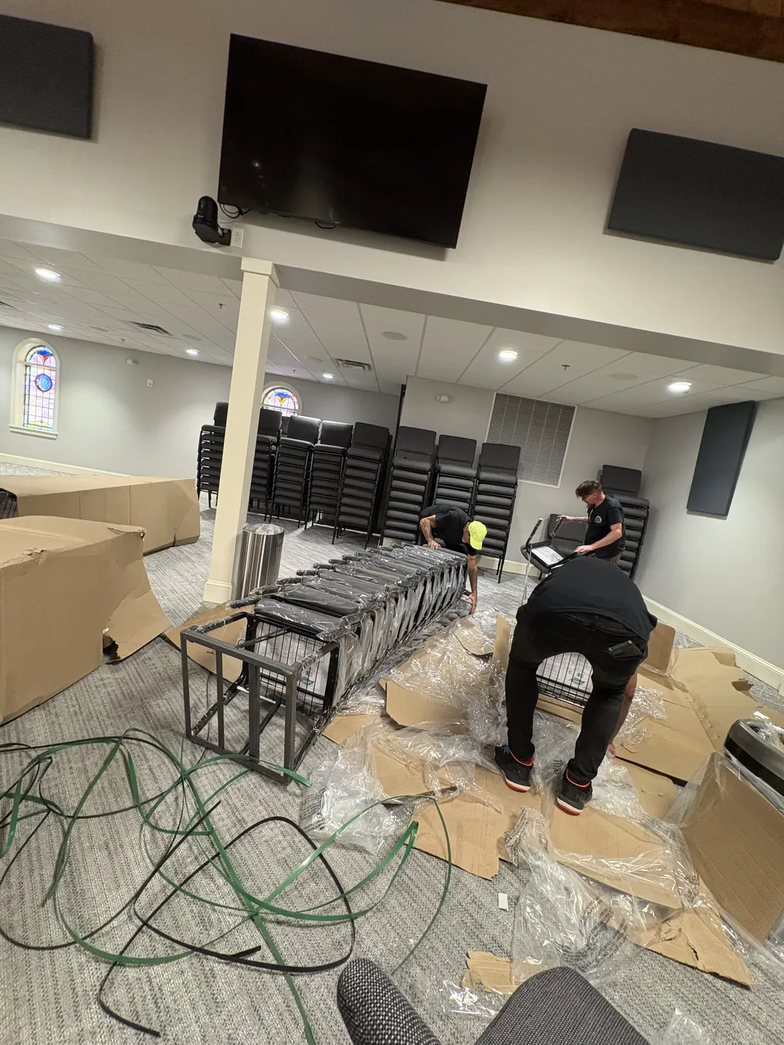 Carter's Moving crew arranging commercial furniture for a Greenville business relocation
