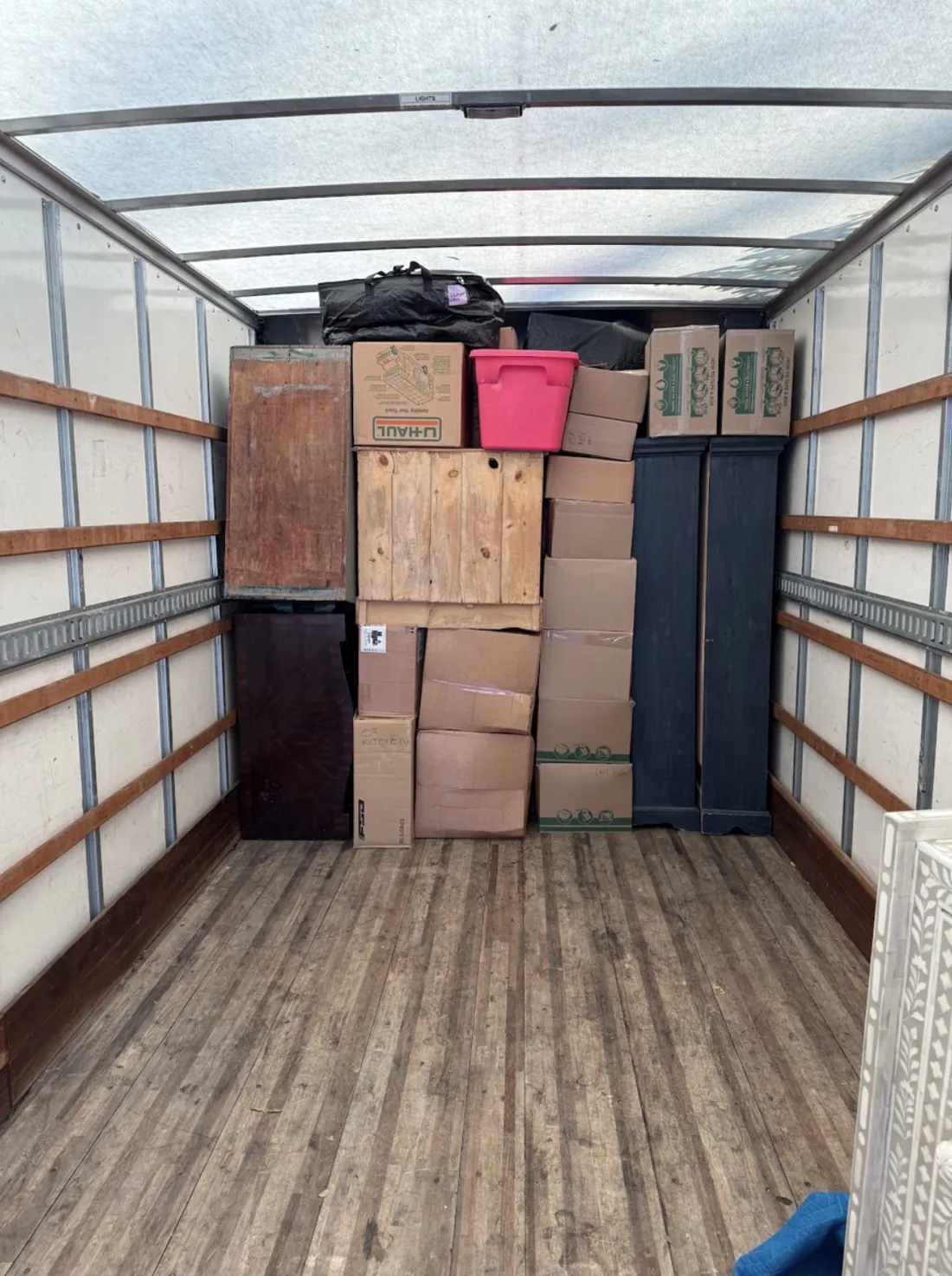 Boxes and household belongings efficiently organized inside a moving truck