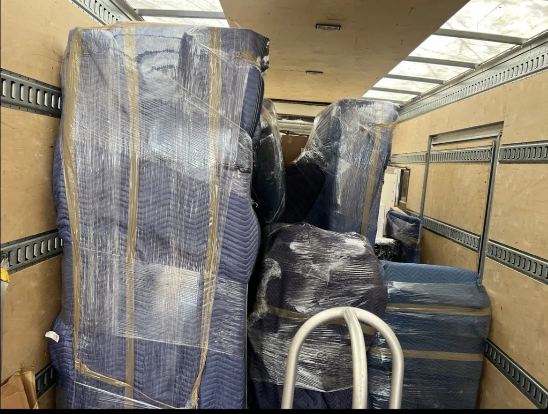 Household furniture protected with moving blankets and secured for careful handling